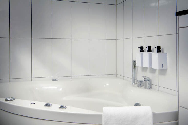 Bathroom with hot tub in suite at Scandic Luleå