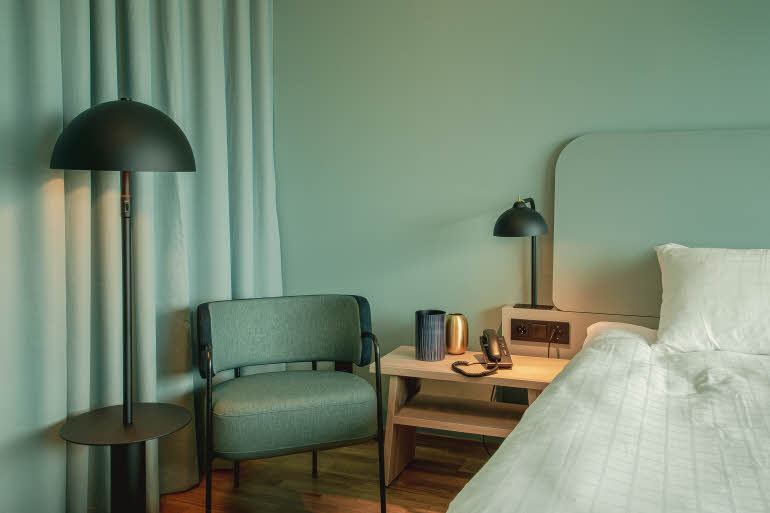 Chair and nights stand in superior room at scandic landvetter in gothenburg
