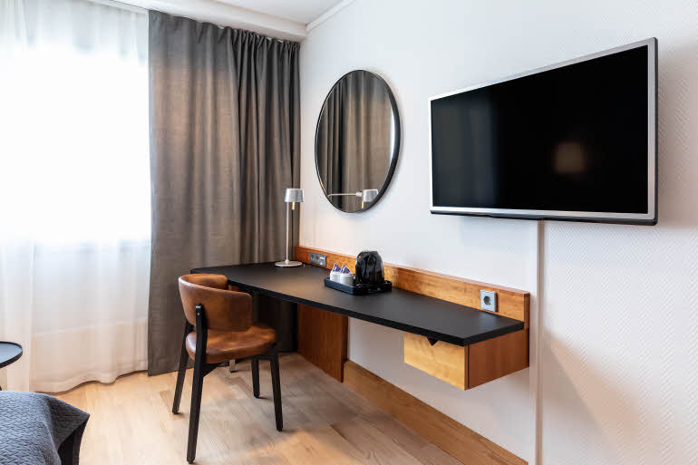 superior room desk and television in scandic espoo finland