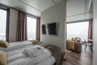 bed and tv in master suite at scandic sortland