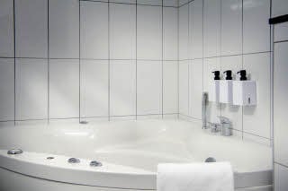 Bathroom with hot tub in suite at Scandic Luleå
