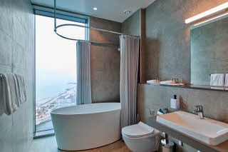 Bathroom with bathtub and view at Scandic Oceanhamnen