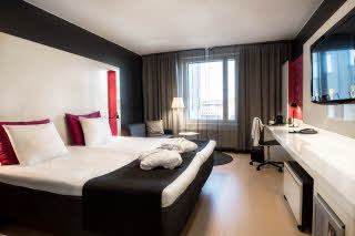 superior room with bathrobes on bed scandic tampere station hotel finland